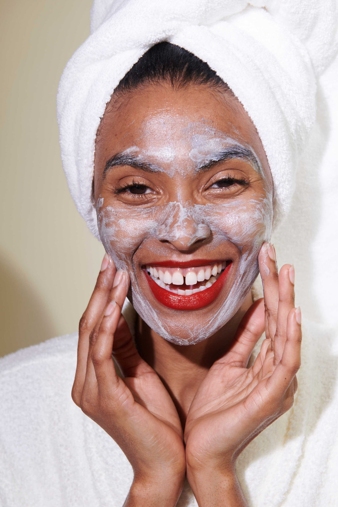 Woman moisturizing face with Savannah Bee Company Royal Jelly Body Butter