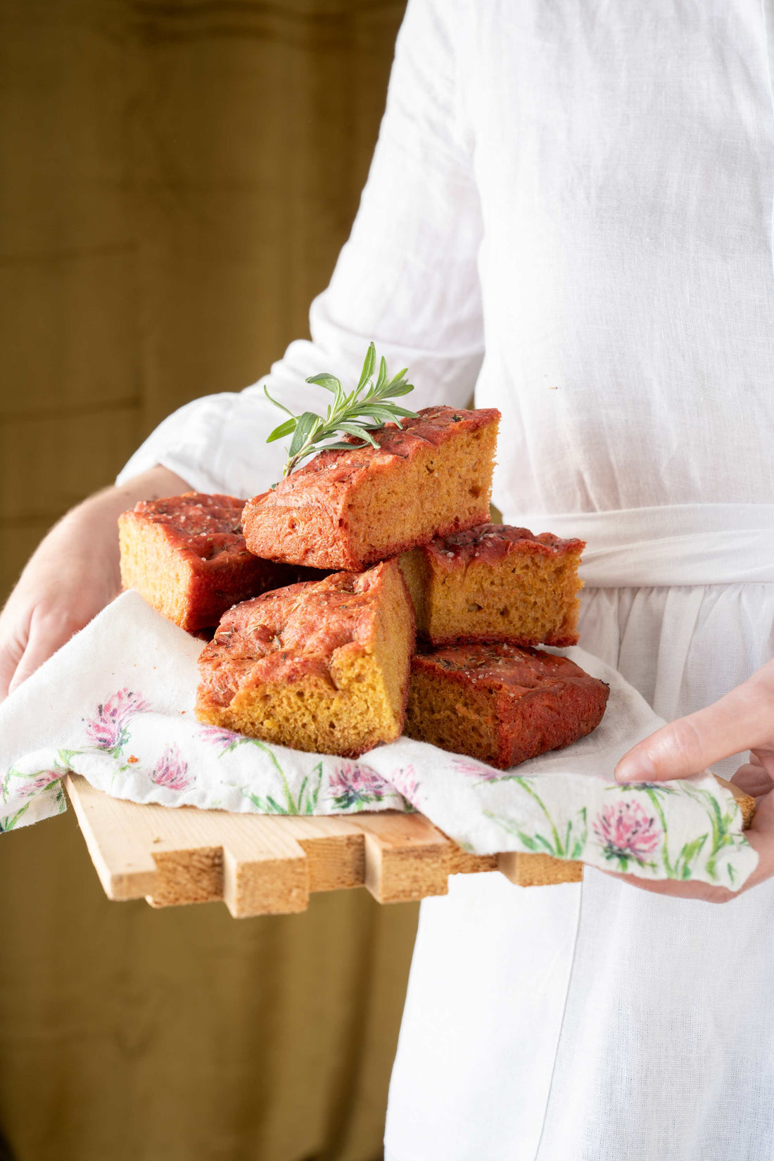 Beet focaccia with honey on a serving board. 