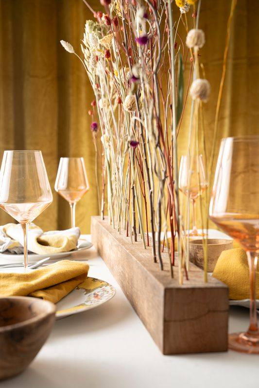 A table scape with a rustic flower centerpiece.