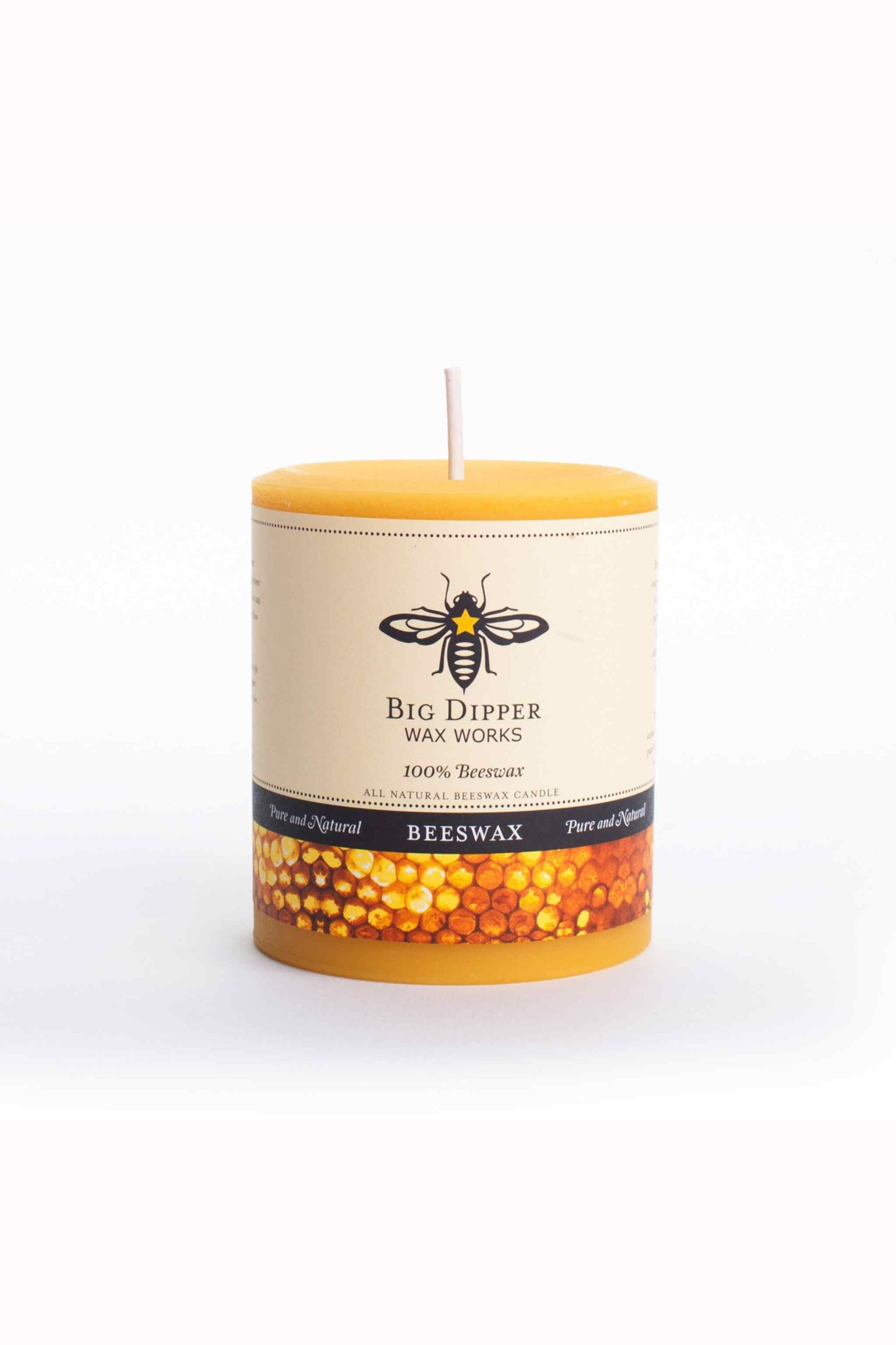 Beeswax candle with a visible brand label on a white background