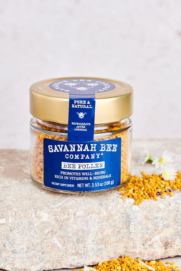 Pure & Natural Savannah Bee Company Bee Pollen 3.53. oz. With a dish and a spoon of bee pollen in the back left corner.