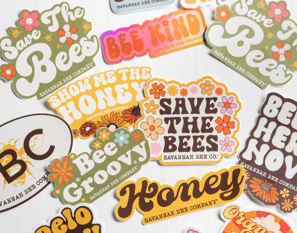 Groovy stickers ranging in all colors promoting different honeys, our brand and our mission to save the bees. 
