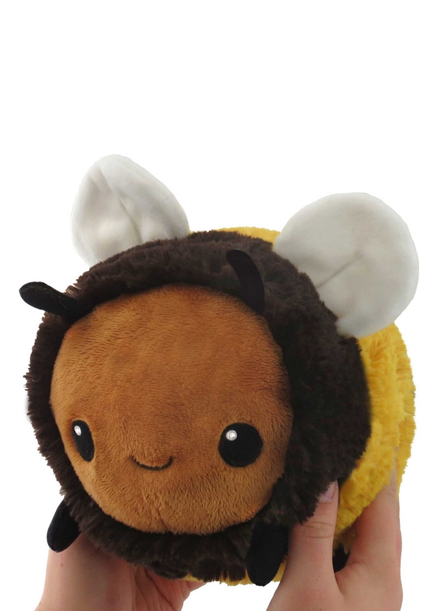 Honey bee stuffed animal held in two hands.