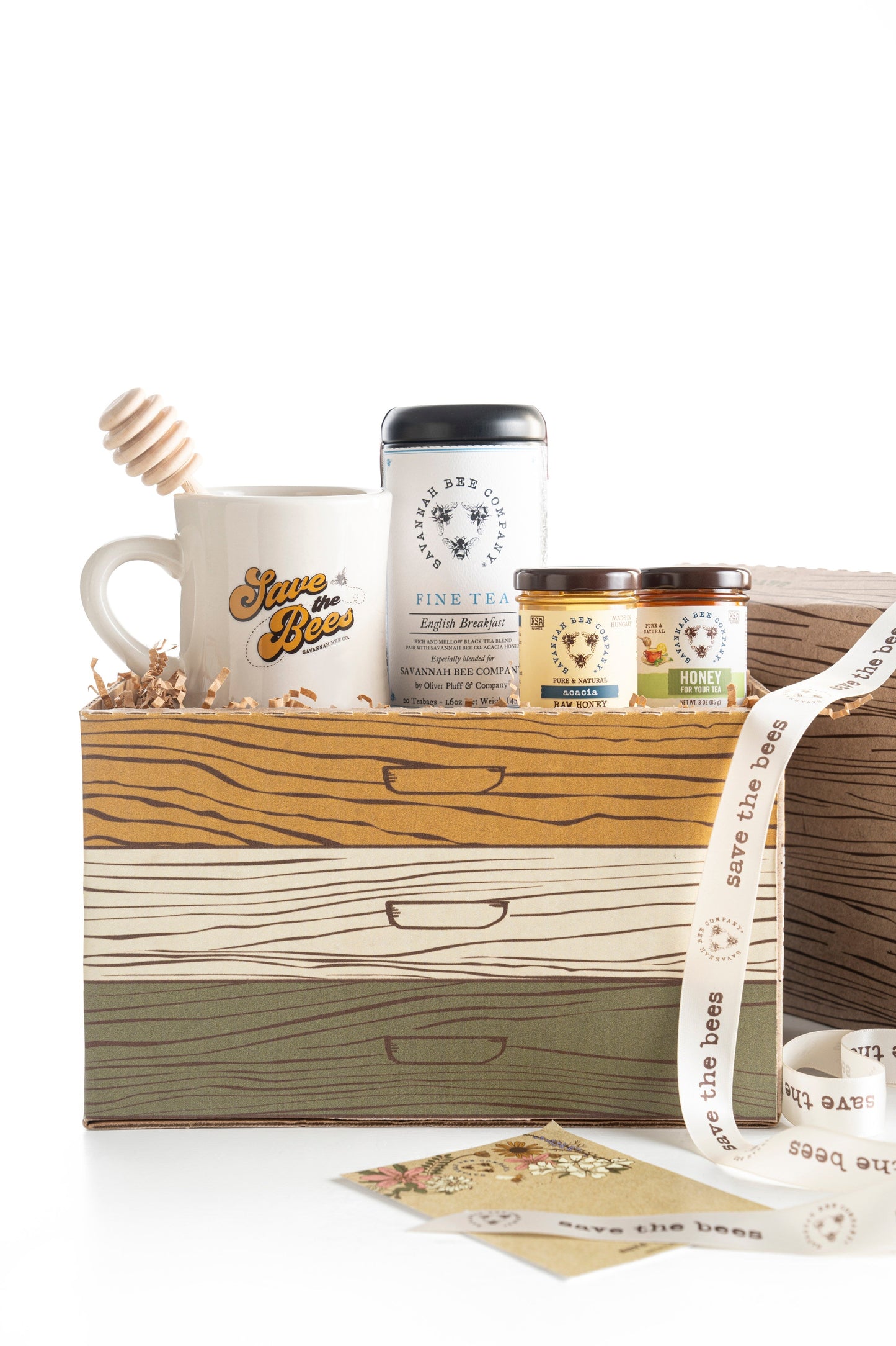 Gift set with a honey dipper, save the bees mug, 3oz acacia honey, 3oz honey for tea, and Savannah Bee Company english breakfast tea in a save the bees gift box