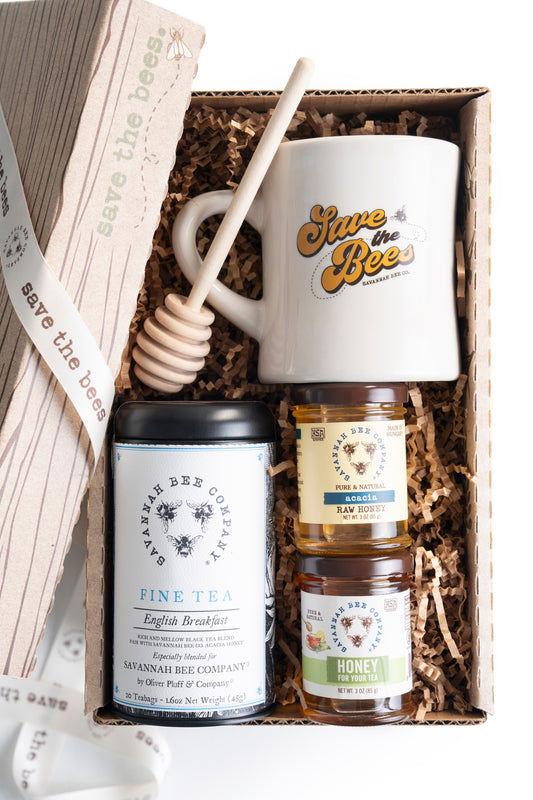 Gift set with a honey dipper, save the bees mug, 3oz acacia honey, 3oz honey for tea, and Savannah Bee Company english breakfast tea in a save the bees gift box from the top