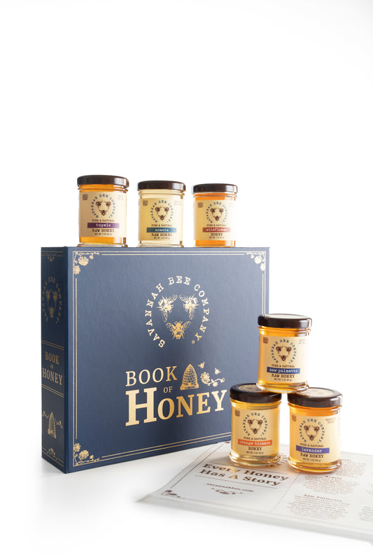 Book of honey gift set with 3 ounce Tupelo, Acacia, Wildflower, Saw Palmetto, Orange Blossom, and Lavender honey against a white background.