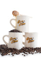 Three diner mugs stacked filled with coffee beans