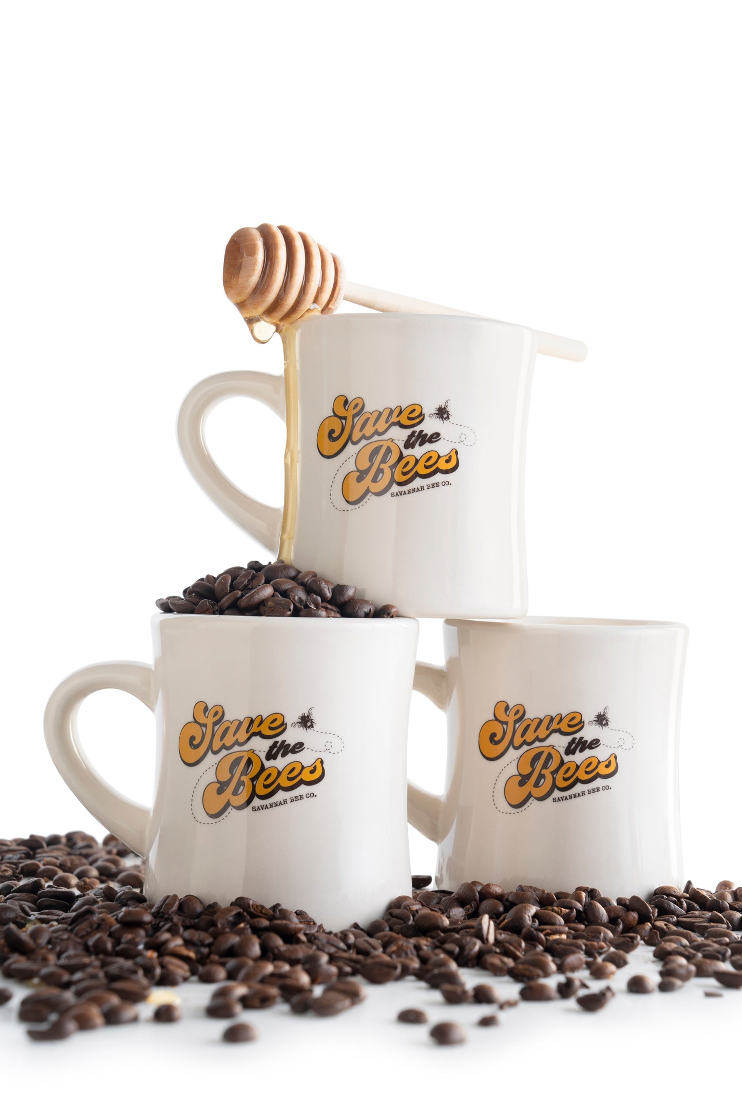 Three diner mugs stacked filled with coffee beans