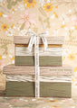 One small and one large gift boxes stacked with a save the bees ribbon tied around them