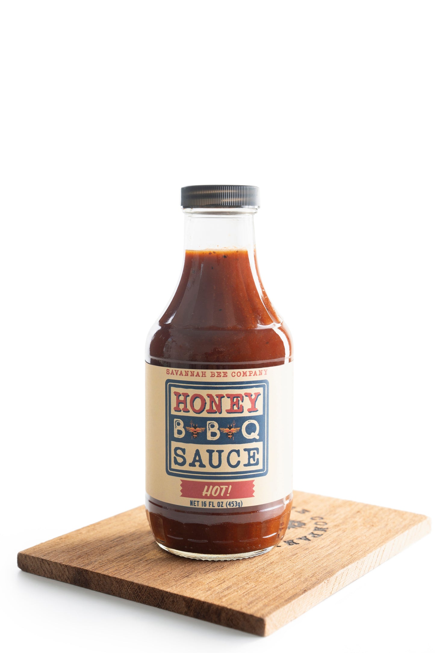 Savannah Bee Company Hot BBQ sauce on a wooden cutting board