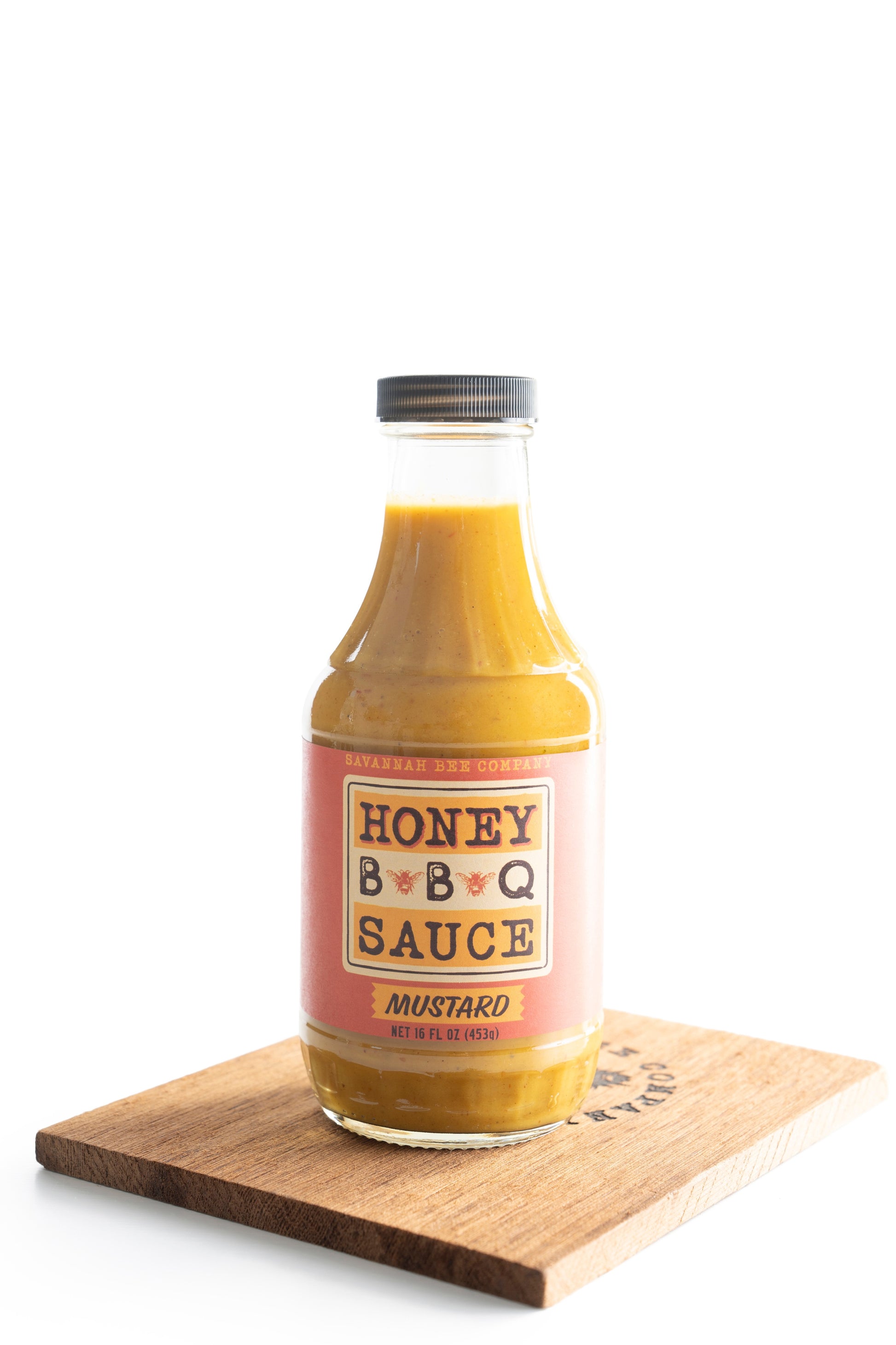 Savannah Bee Company mustard BBQ sauce on a wooden cutting board