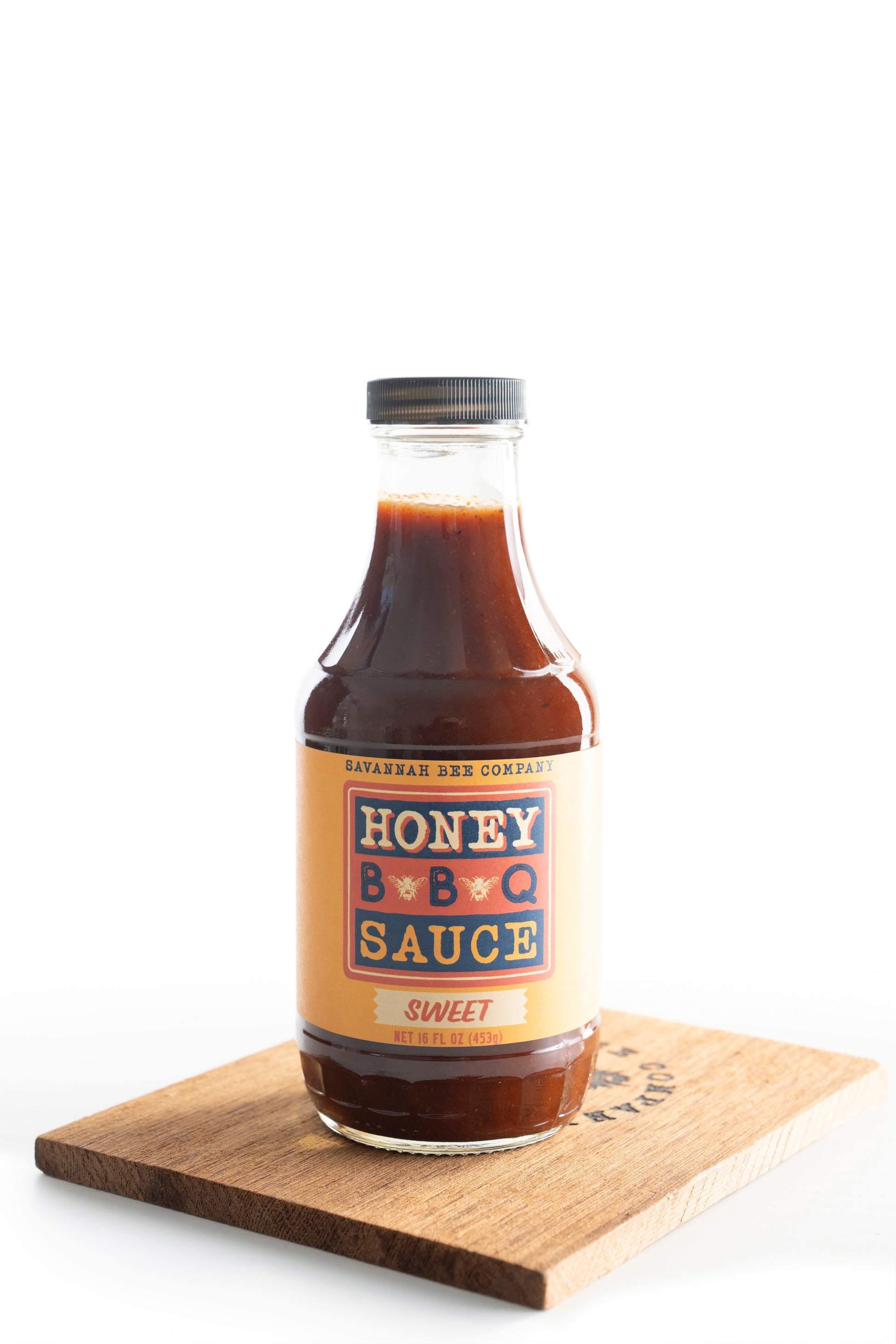 Savannah Bee Company sweet BBQ sauce on a wooden cutting board