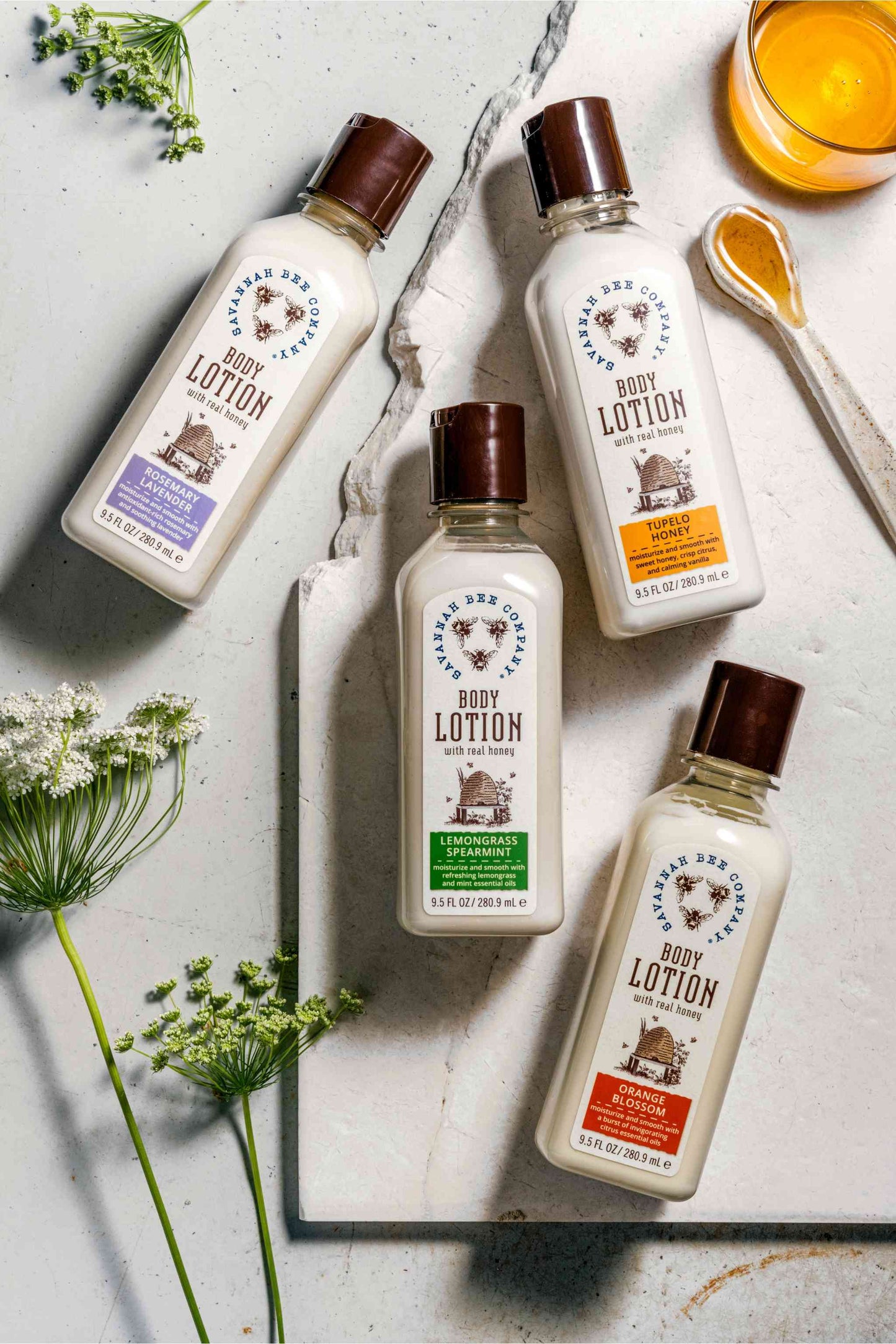 Rosemary Lavender, Tupelo Honey, Lemon Spearmint and Orange Blossom Body Lotion next to honey and flowers