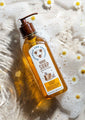 Tupelo Honey Hand Soap 9.5 fl. oz. in water with white flowers.