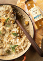 Honey Roasted Pumpkin Risotto in a dutch oven with a wooden spoon.  featuring our Acacia Honey