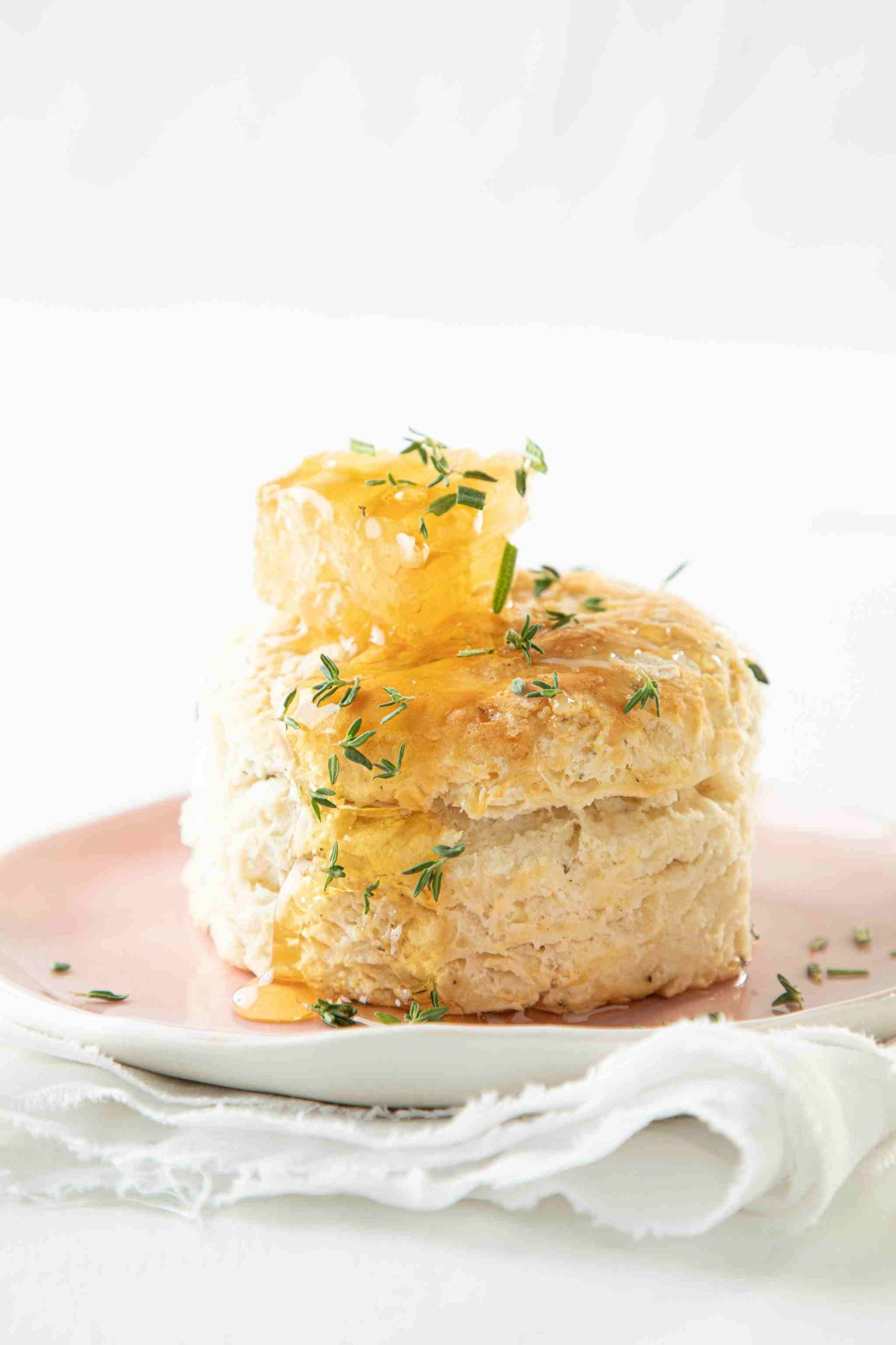 Biscuit on a plate with honeycomb on the top.