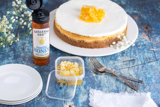 Vanilla honey cheesecake with a jar of honey and honeycomb. 