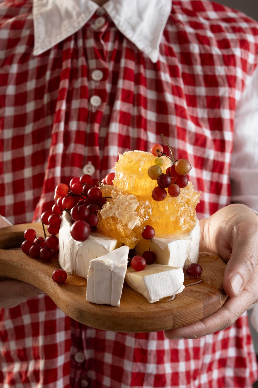 Cheese platter with honeycomb on top.