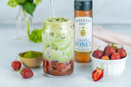 Strawberry Matcha with a bowl of strawberries and Savannah Bee vanilla honey.