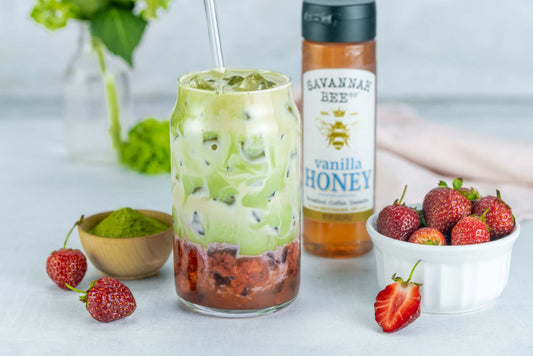 Strawberry Matcha with a bowl of strawberries and Savannah Bee vanilla honey.