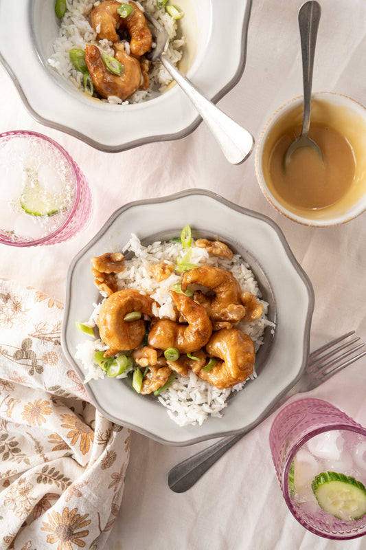 Honey walnut shrimp on a serving platter with a side of creamy soy-honey sauce.