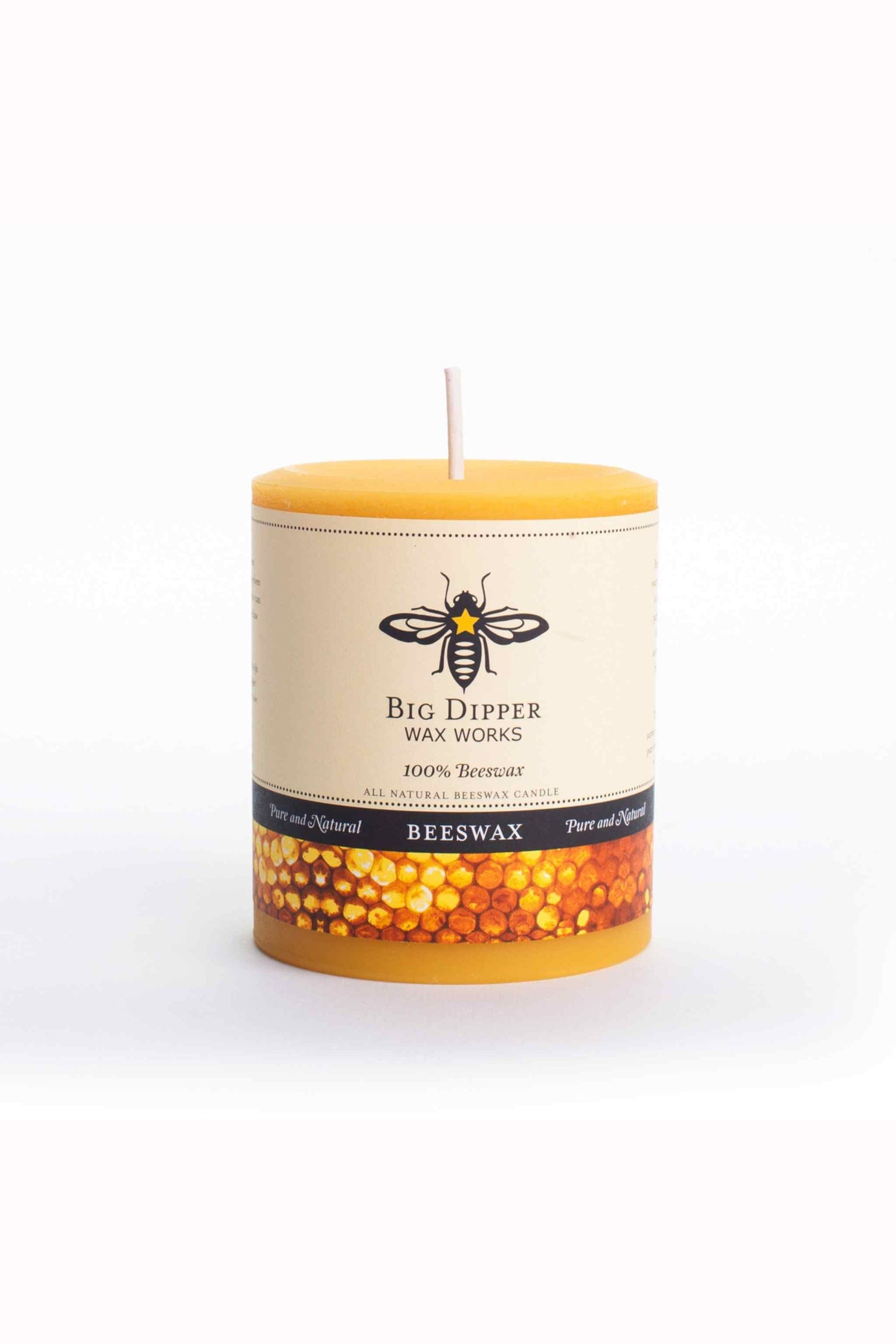 Beeswax candle with a visible brand label on a white background