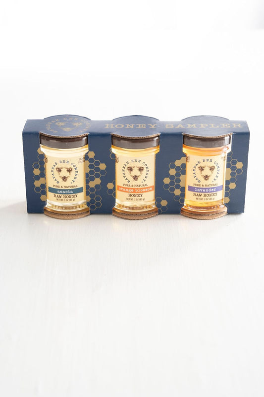 Pure & Natural Acacia 3 oz. mini, Orange Blossom 3 oz. mini and Lavender 3 oz. mini Raw Honey gift in blue packaging with gold honeycomb print.