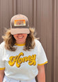 Savannah Bee Employee modeling the Bee Box trucker hat.