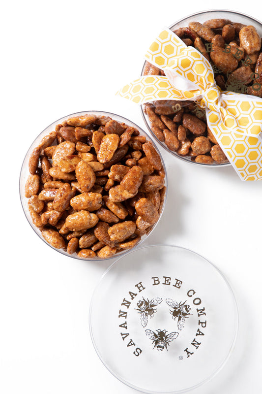 Honey Crisp Pecans in a acrylic Savannah Bee Logo tin with a ribbon.