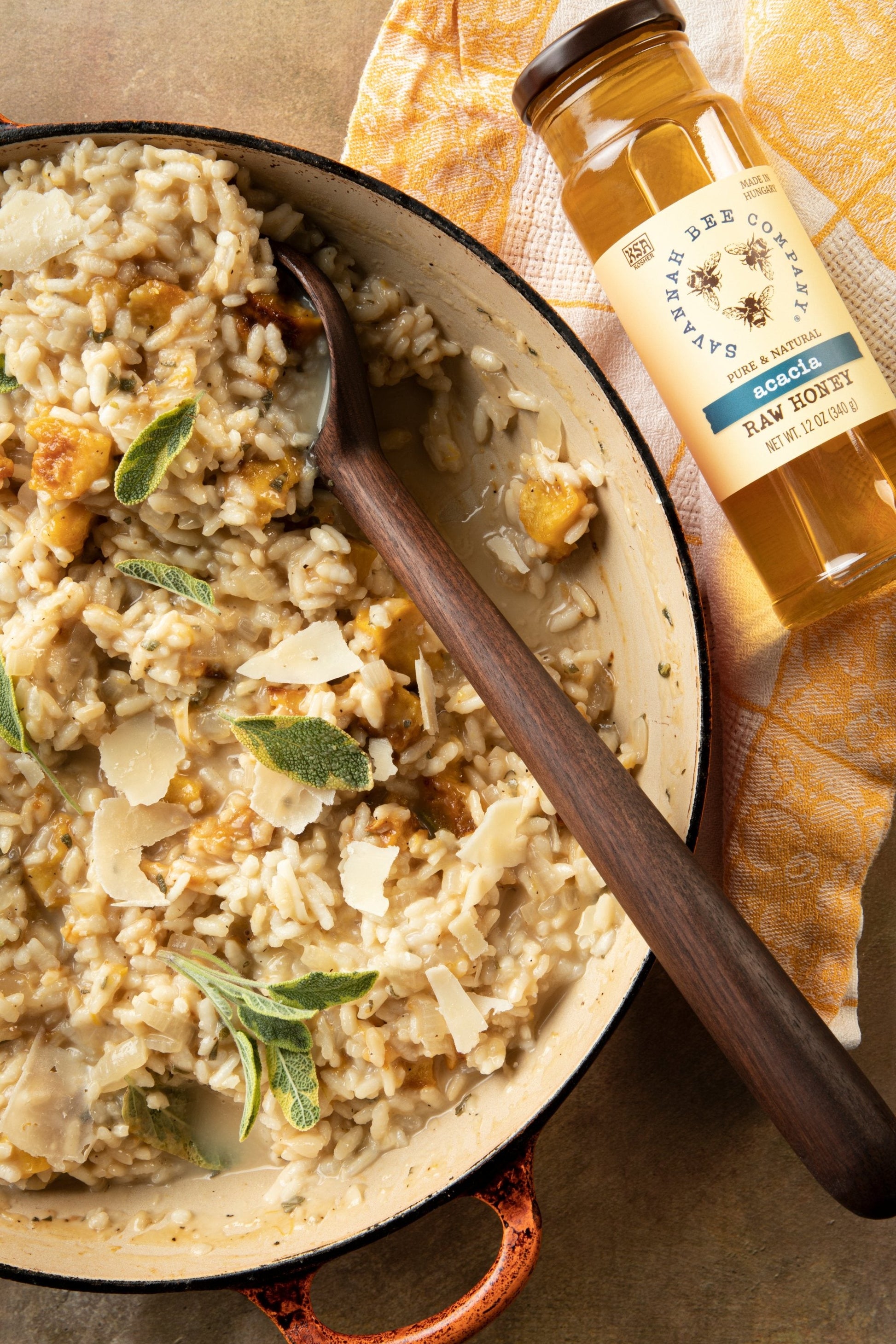 Honey Roasted Pumpkin Risotto in a dutch oven with a wooden spoon. featuring our Acacia Honey