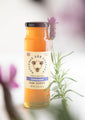 Pure & Natural Lavender Raw Honey 12 oz. surrounded by lavender sprigs.