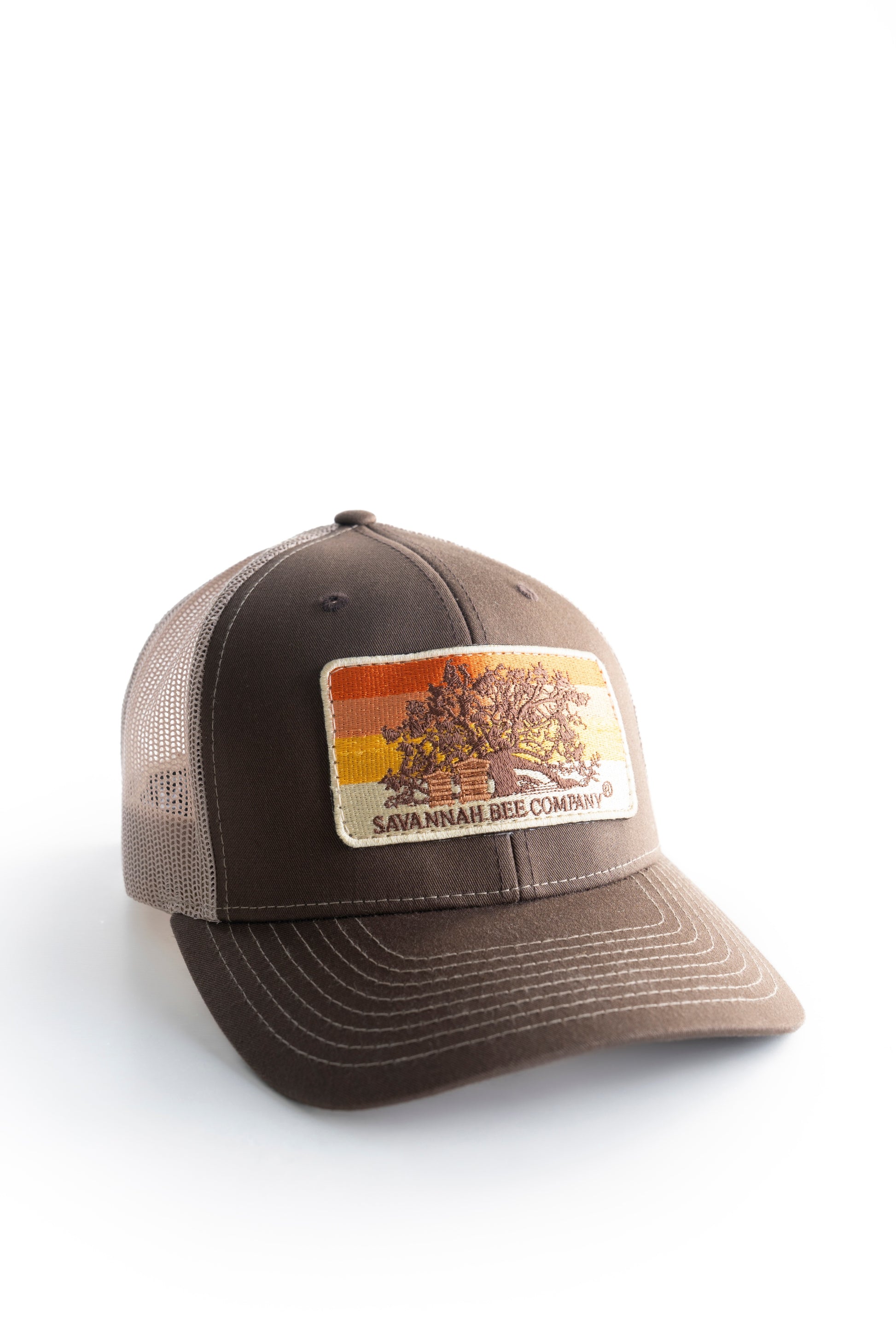 brown trucker hat with oak tree and bee boxes facing left