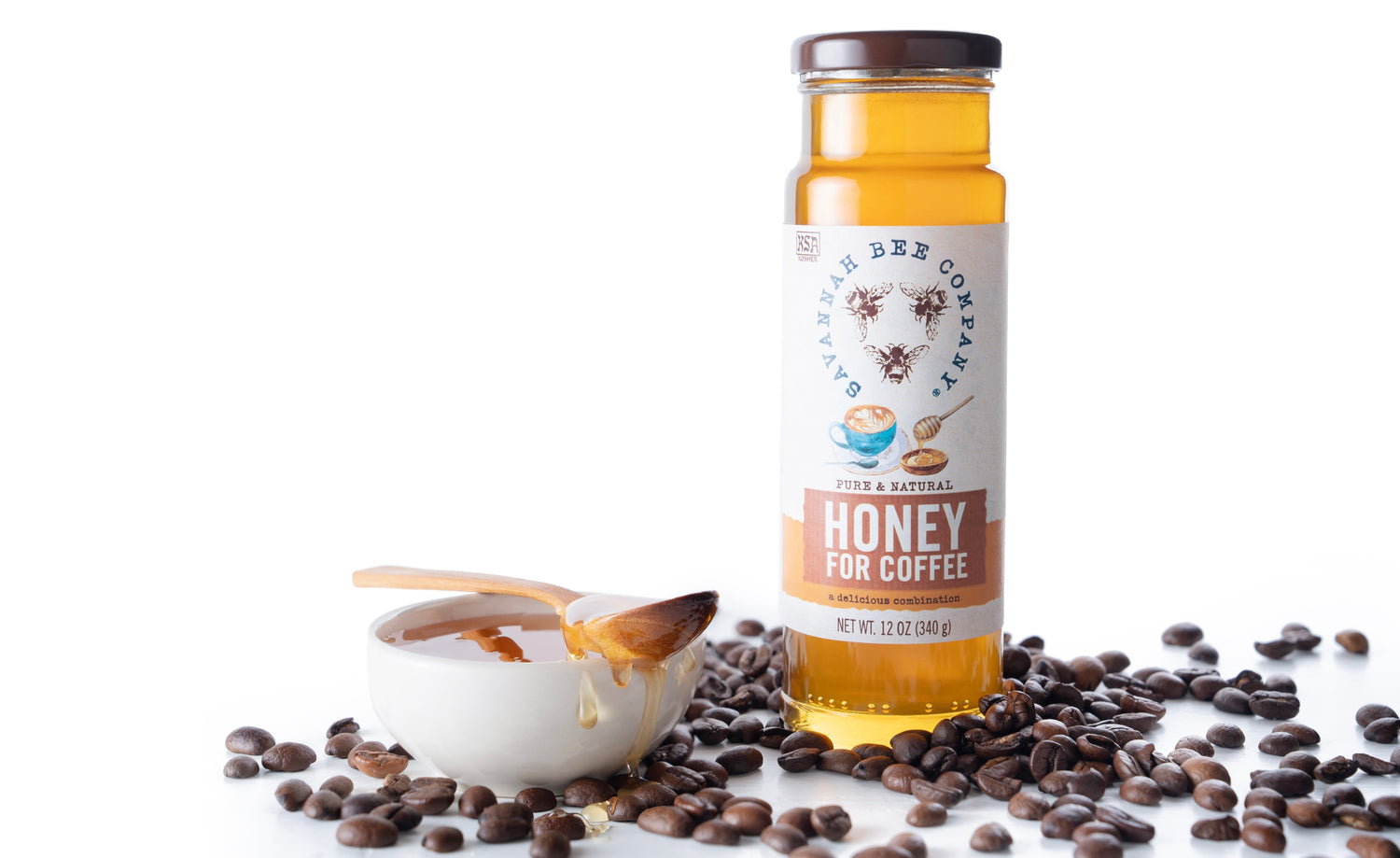 Honey for Coffee surround by coffee beans with a dish of honey on the left side