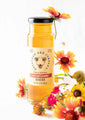 12 ounce wildflower honey next to a bouquet of wildflowers.