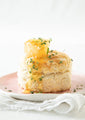 A fluffy biscuit, plated with a sprinkle of rosemary and Acacia Honeycomb on top.