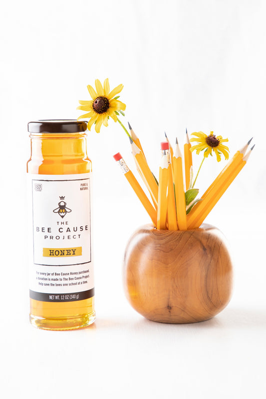 The Bee Cause Project Honey 12 oz. tower featuring yellow daisy's and wooden pencil holder