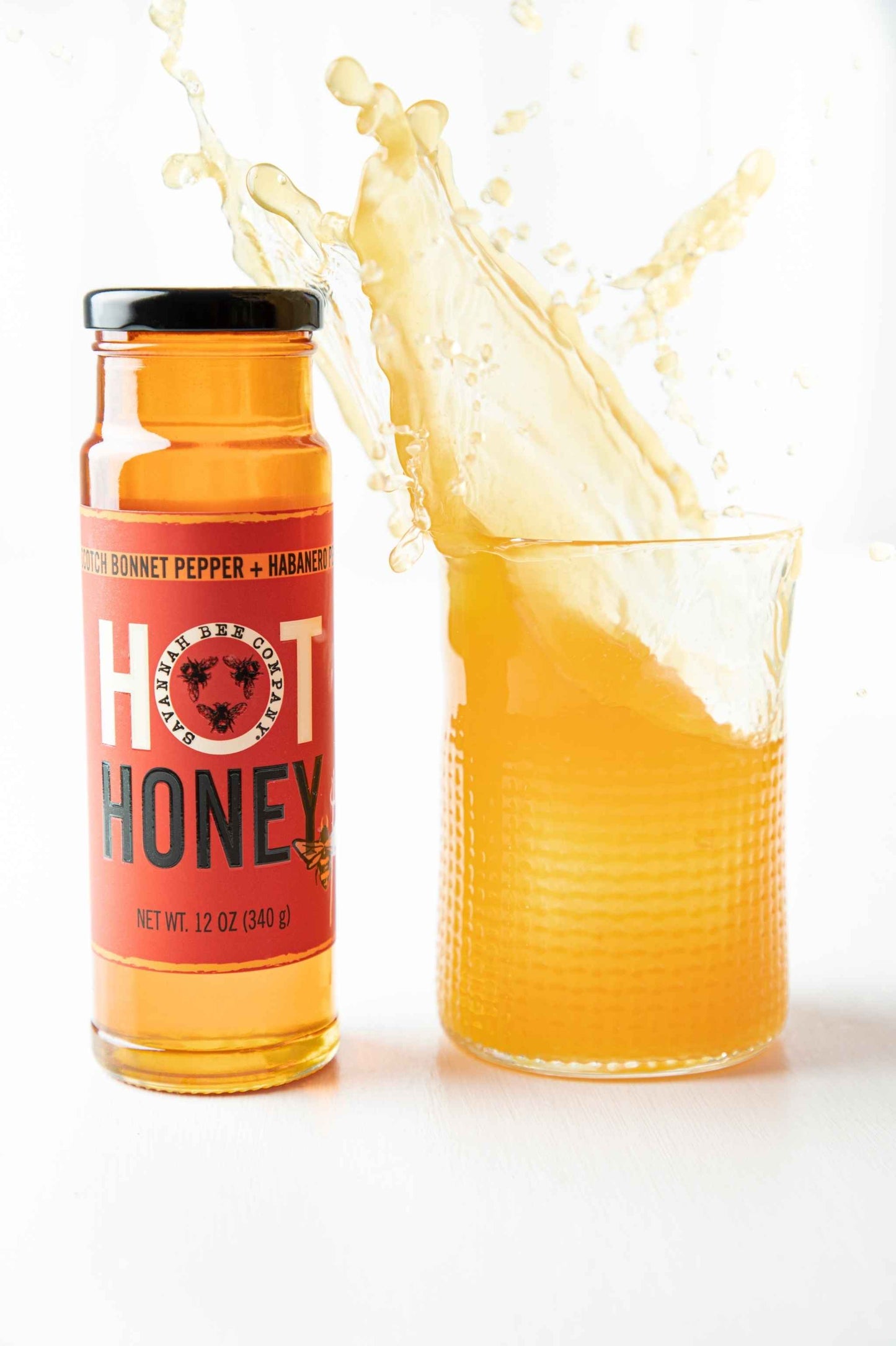 Scotch Bonnet and Habanero Peppers Hot Honey 12 oz. tower