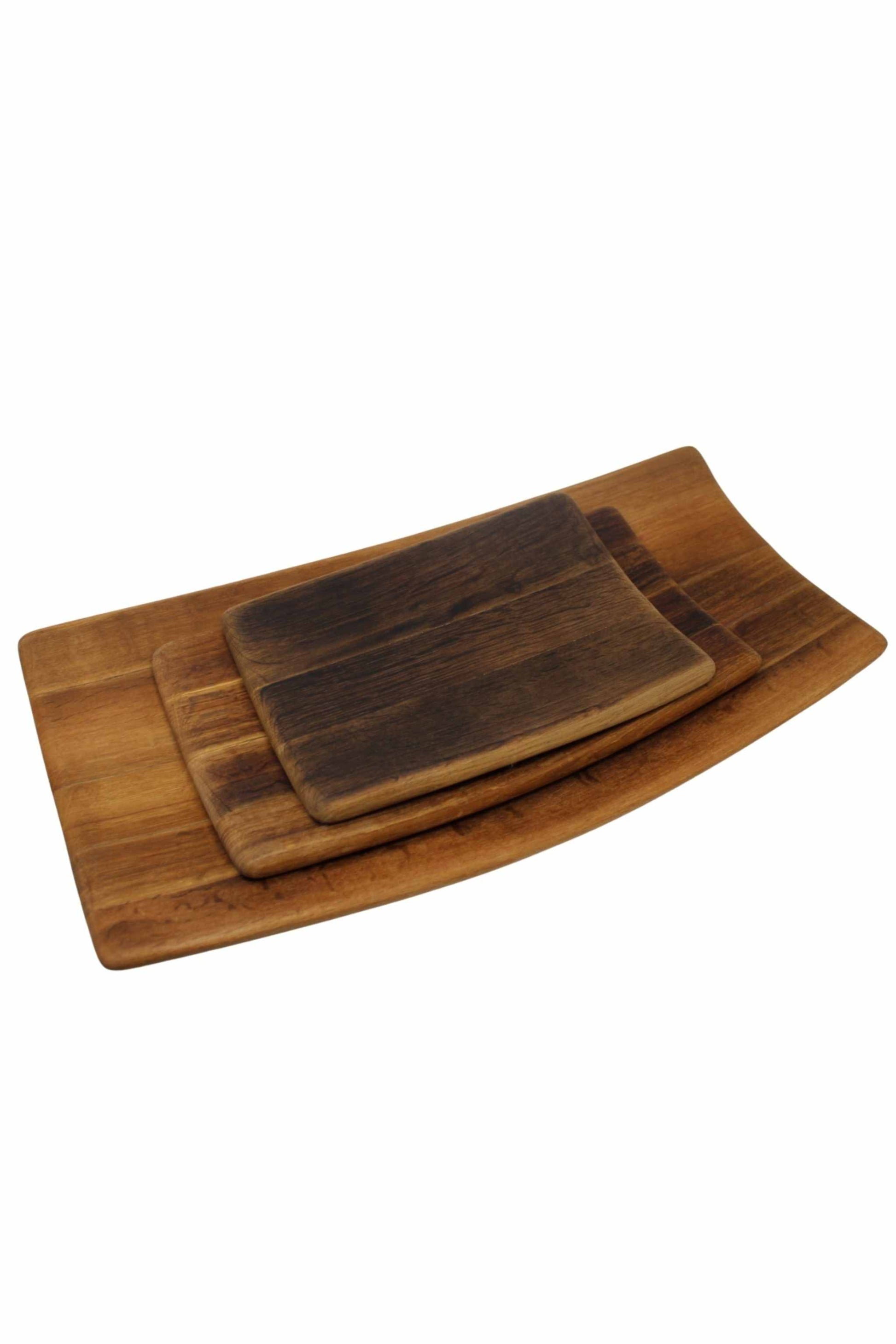 Three sizes of wine barrel platters grouped together. 
